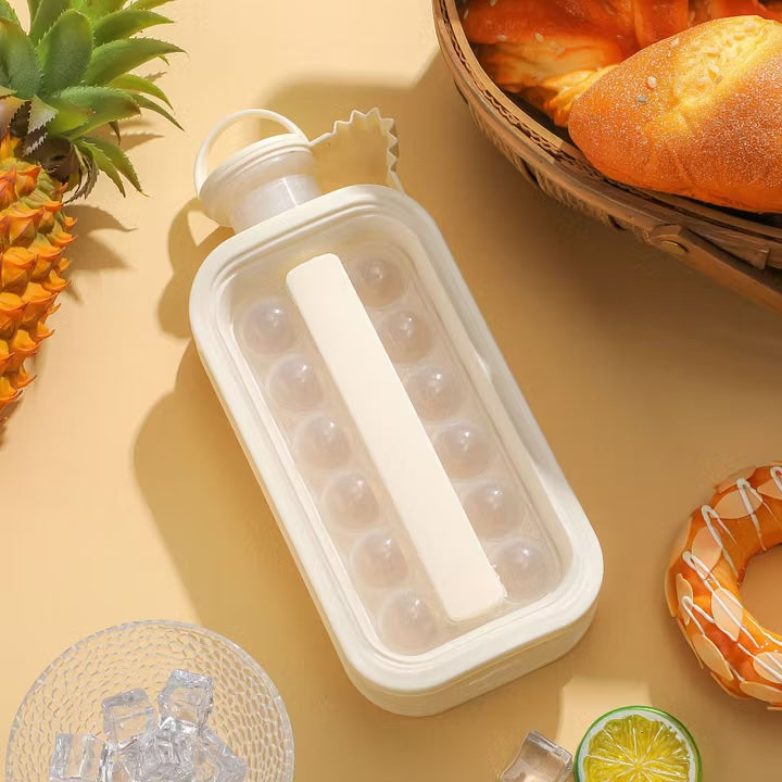 White ice ball kettle from above beside a bowl of ice, lemon and pastries
