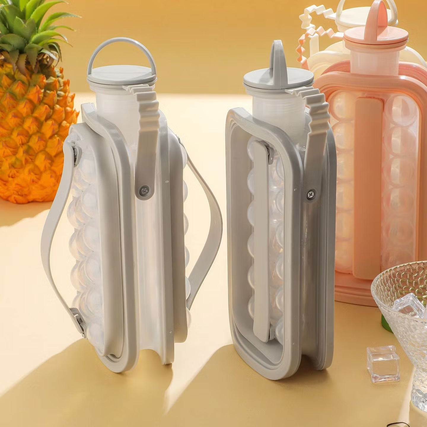 Side view of two ice ball kettles folded flat, showing the slim profile and carry handles